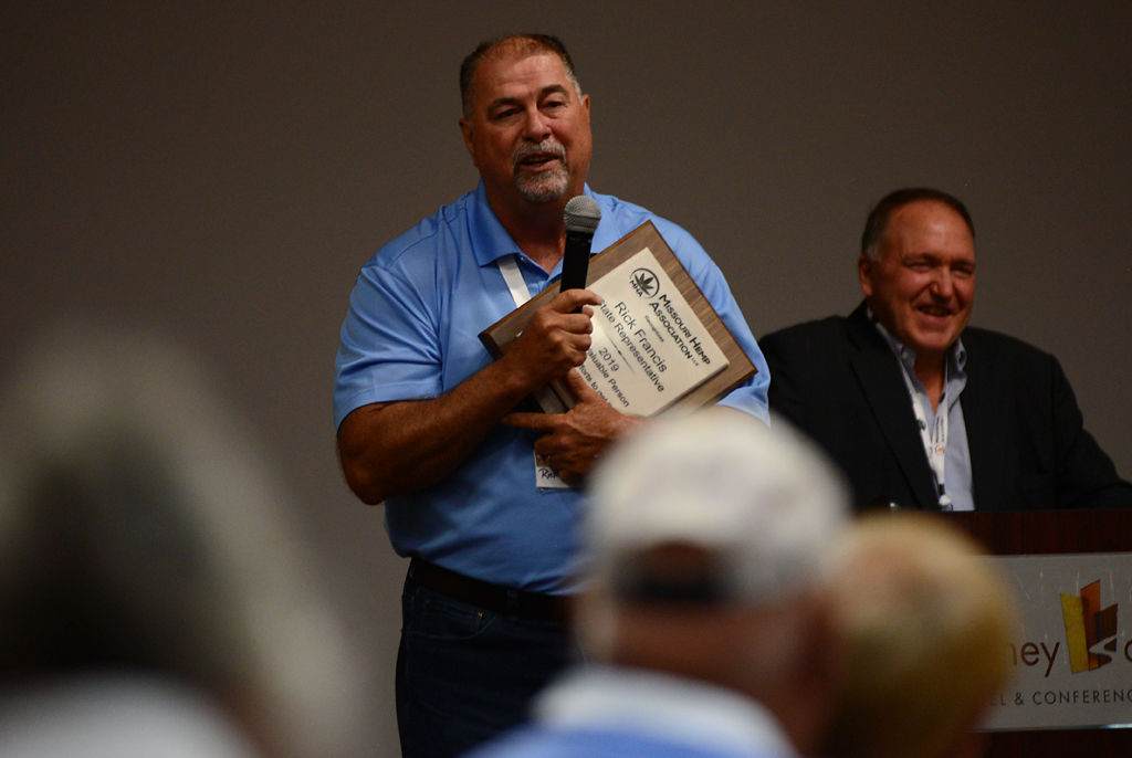 Rep. Rick Francis, R-Perryville , left, receives an MVP award from Dale Ludwig